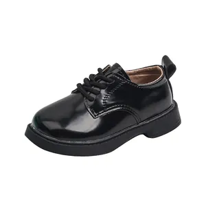 Classic black patent leather children's lace-up dress shoes with thick rubber soles