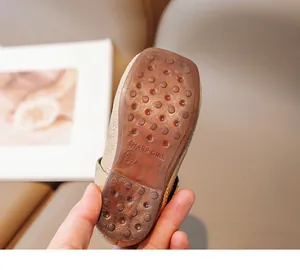 Close-up of non-slip rubber sole with dot texture and brand logo for kids shoes