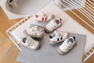 Close-up of baby walking shoes with bear embroidery and breathable mesh texture
