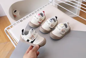 Detail of toddler sneakers with cute bear embroidery and double hook-and-loop straps
