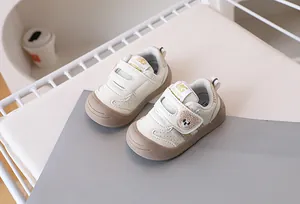 Close-up of baby walking shoes with bear embroidery and double hook-and-loop closure