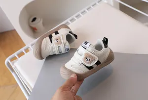 Detail of baby walking shoe with cute bear embroidery and convenient velcro strap closure