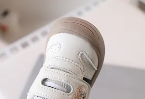 Close-up of baby walking shoe with breathable leather, bear embroidery and anti-collision toe