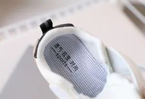 Detail of baby walking shoe showing breathable honeycomb insole and padded collar