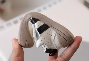 Detail showing the flexible soft sole and breathable upper of baby walking shoes