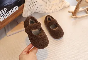 Detail of plush brown Mary Jane baby shoes with warm lamb wool texture for winter