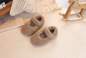 Detail view of plush tan Mary Jane toddler shoes featuring warm shearling texture and strap