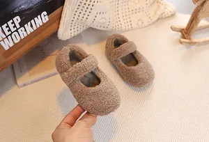 Close-up of the thick brown lamb wool texture on cozy winter Mary Jane baby shoes