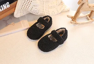 Detail of plush black faux lamb wool baby Mary Jane shoes with velcro straps for toddlers