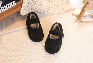 Detailed close-up of girls black faux lamb wool Mary Jane shoes with warm plush lining