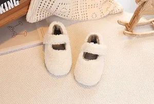 Detail of plush cream teddy fleece Mary Jane shoes for girls on cozy knit background