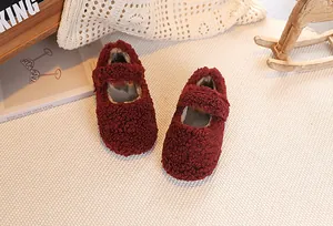 Macro detail of burgundy faux shearling kids Mary Jane shoes with warm plush lining