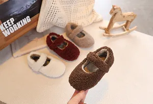 Detail of baby plush Mary Jane shoes in four warm colors on a cozy lifestyle background