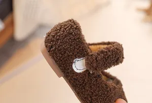 Detail of dark brown faux lamb wool texture and velcro strap on children winter shoes