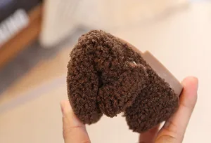 Detail of flexible brown plush children shoes showing high soft sole and warm texture