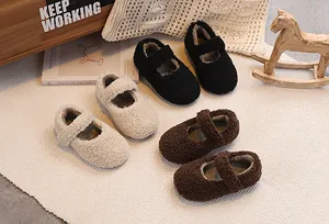 Detailed overhead view of plush baby Mary Jane shoes in beige, black, and dark brown colors