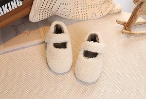 Detailed close-up of plush off-white Mary Jane shoes with lamb wool texture and strap