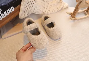 Detail of plush beige Mary Jane toddler shoes with fleece texture and velcro strap