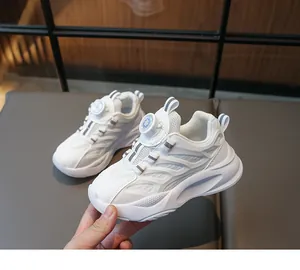 Close-up of children's white sneakers featuring the rotary dial lace-up system