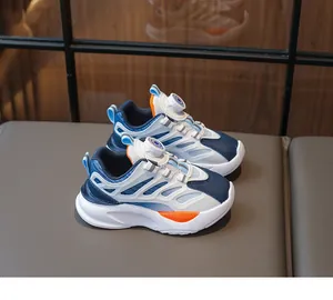 Detail of kids athletic shoe with blue and orange panels and rotary buckle closure