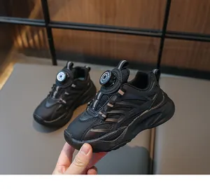 Detail of kids black running shoes with breathable mesh and easy rotary buckle system