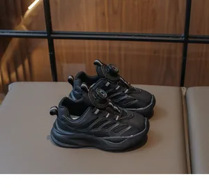Close-up of kids black running shoes with breathable mesh and quick-dial buckle system