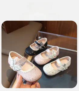 Detail of sequined Mary Jane shoes for girls featuring lace bows in four color options