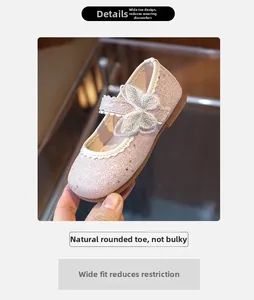 Detailed view of pink glitter Mary Jane shoes with hollow butterfly applique and velcro strap