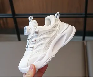 Detail of children's white mesh sneakers featuring an easy rotary buckle closure system