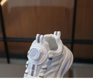 Close-up of children's white sneakers featuring the convenient rotary buckle system