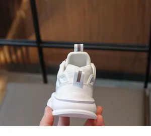 Detail view of white kids sports shoe heel with mesh texture and pull tab for easy wear