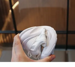 Detailed view of flexible sole construction on white children's lightweight running shoes