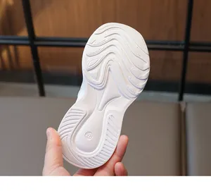 Close-up of white anti-slip shoe sole with water ripple pattern and size 28 engraving