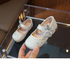 Detailed view of silver glitter Mary Jane girl shoes with bow and star patterns
