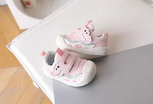 Detail of pink toddler walking shoes with breathable mesh and cute cartoon strap