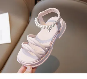 Dettaglio ravvicinato di sandali rosa per bambine con perle e suole spesse antiscivolo
