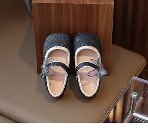 Navy blue sequin Mary Jane girl shoes featuring a delicate mesh bow and pearl strap