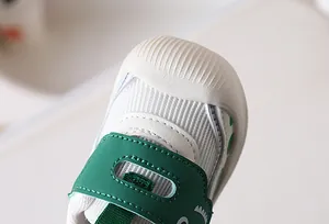 Detail of baby walking shoes with rubber toe cap and mesh fabric for safety