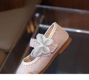 Close-up of pink sequin girl's princess shoes with large embroidered bow detail