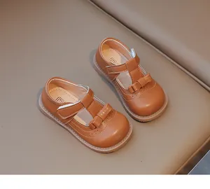 Détail de chaussures Mary Jane marron pour filles avec nœud et perforations brogue