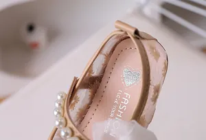 Detail of girls princess shoe featuring mesh flower embroidery and pearl trim accents