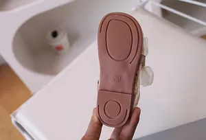 Detail view of anti-slip rubber sole with grid pattern for children mesh shoes