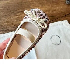Detail of pink sequin girls flats with ribbon bow and rhinestone accents