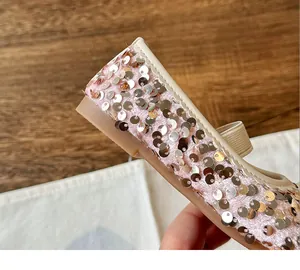 Detailed view of pink girls sequin flat shoes with silver sparkles and fine stitching