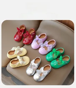 Overhead view of shiny patent leather girl's Mary Jane shoes with mesh bows in five colors
