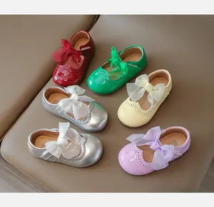 Detail view of colorful girls' mary jane shoes with mesh bows and brogue patterns