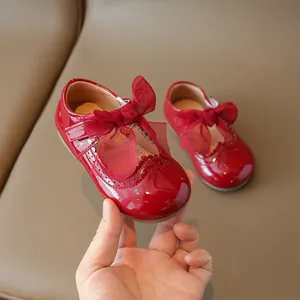 Red patent leather baby girl shoes with large organza bow and scalloped lace trim