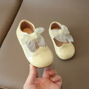 Girl's cream yellow princess shoes with mesh bow and perforated wingtip detail