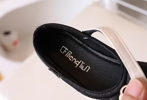 Detail of soft inner lining and brand logo on white Mary Jane shoes for girls