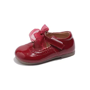 Red patent leather girls' Mary Jane shoes with mesh bow and hollowed floral detail